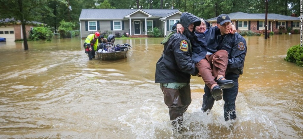 Woman being carried out of a flood