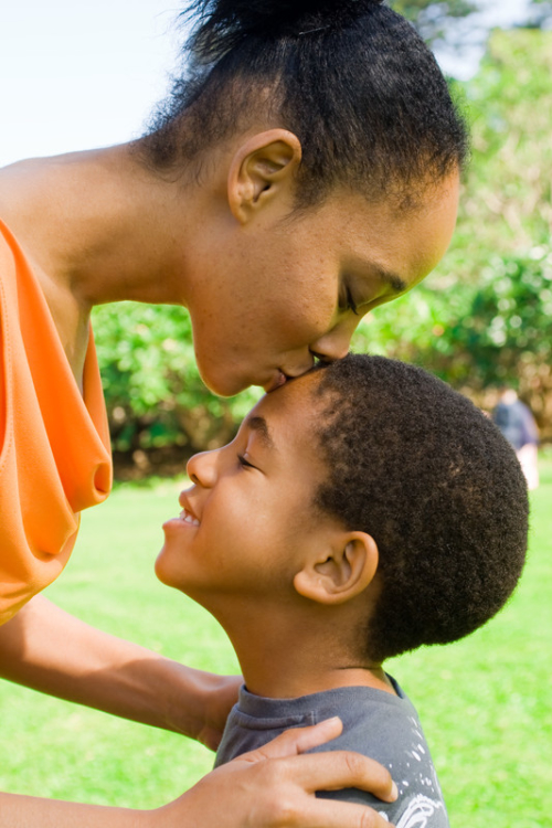 Mother kissing child on forehead