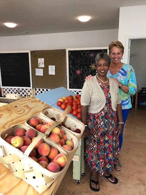 Women standing by produce