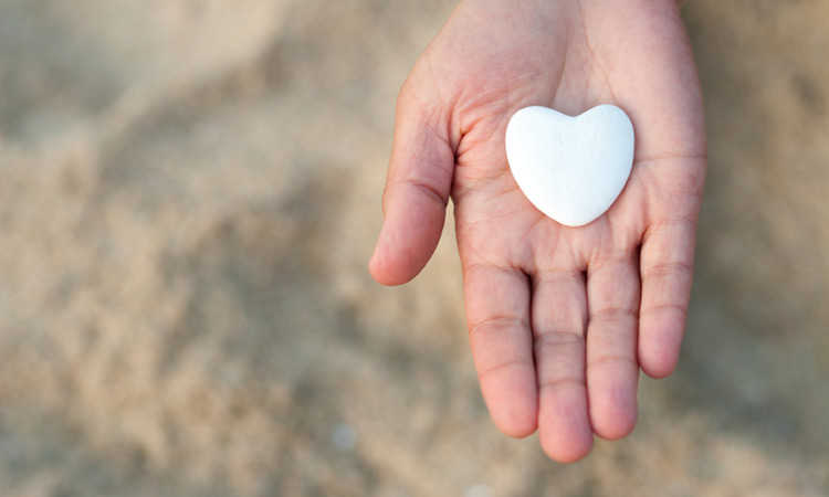 Heart shaped stone in hand